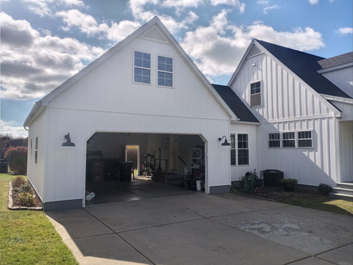 White board-and-batten siding on a home and attached garage